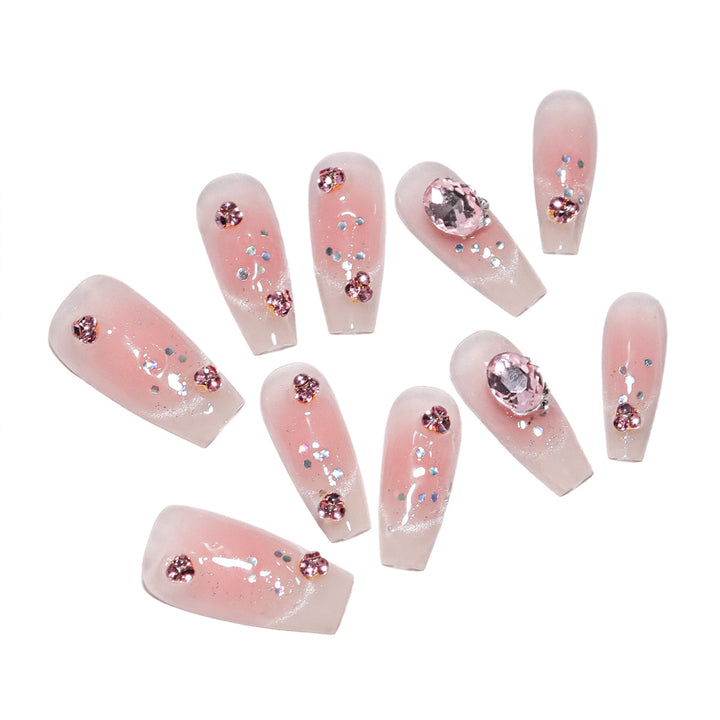 Artificial nail extensions with artistic glitter accents Bowlift