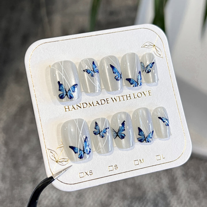 Creative nail extensions with intricate butterfly design Bowlift