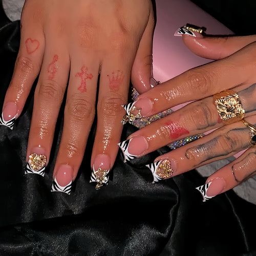 Artistic Zebra-Patterned Nail Enhancements with Gem Accents Bowlift