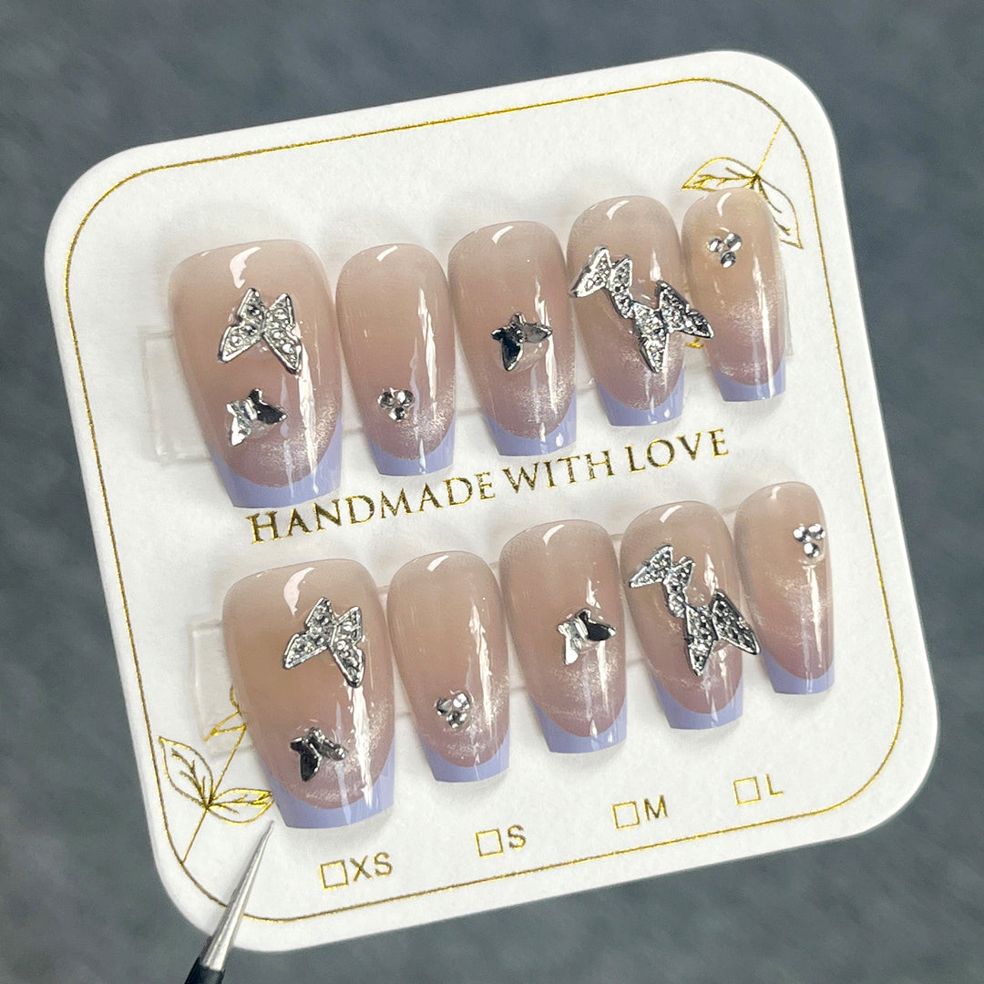 Artificial nail extensions with glitter design and elegant accents Bowlift