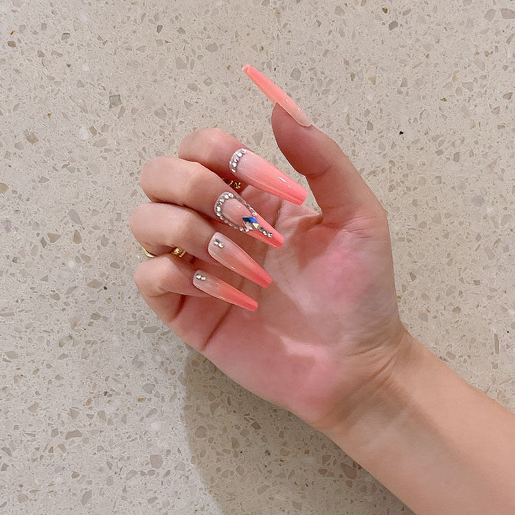 Artificial nails with glitter and stone embellishments Bowlift