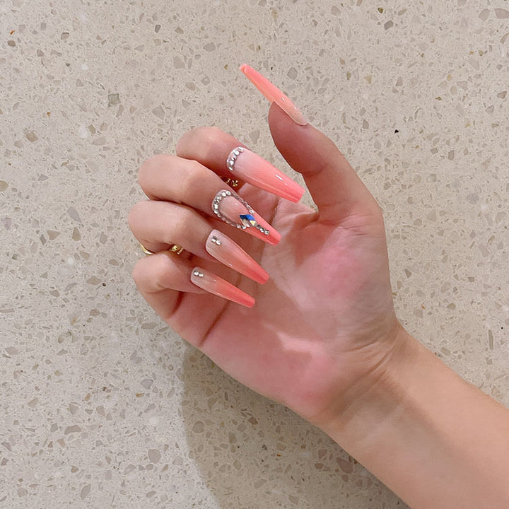 Artificial nails with glitter and stone embellishments Bowlift