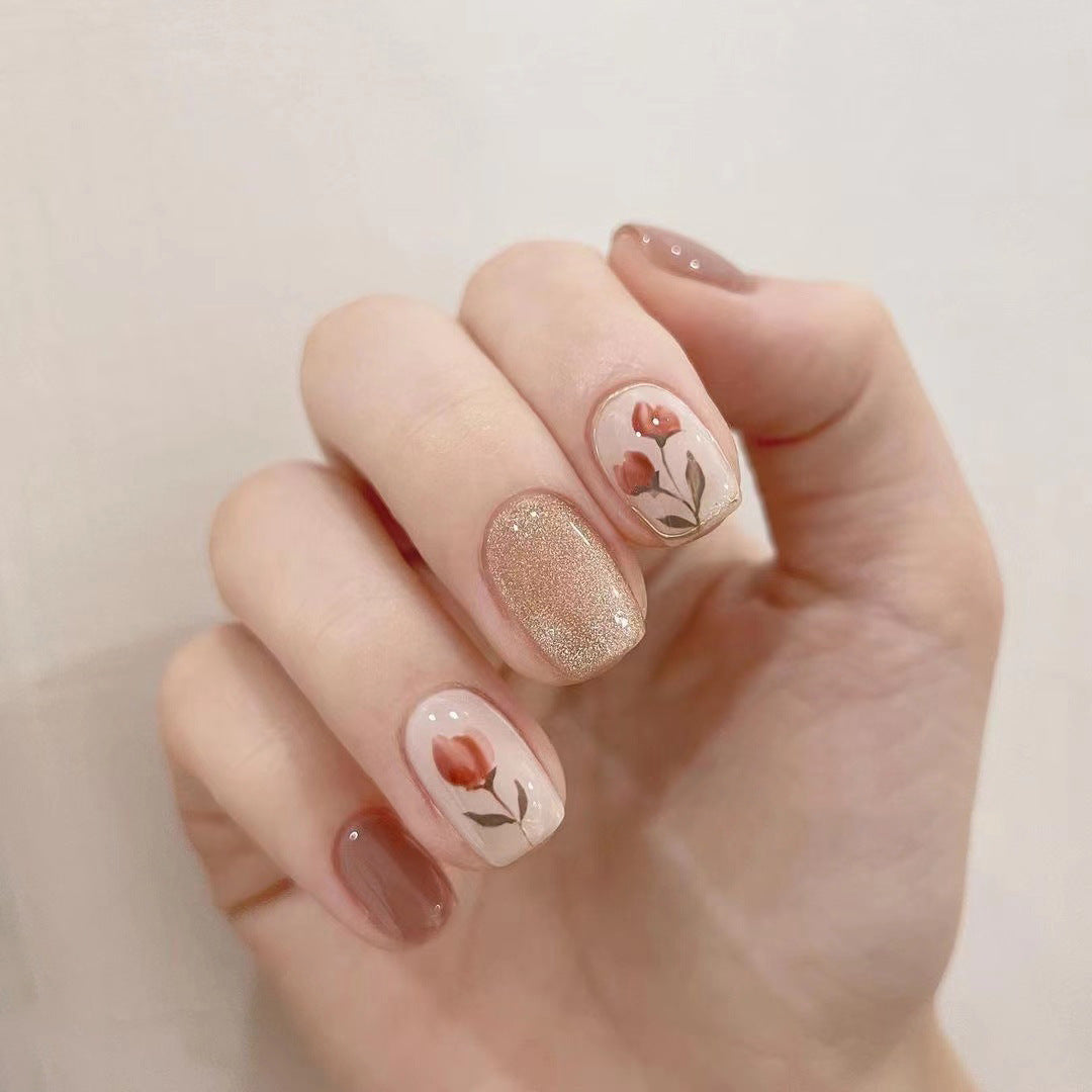 Artificial nail art with colorful flower design and glitter accents Bowlift