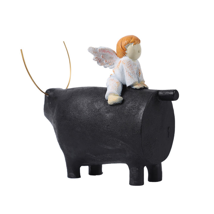 Decorative Angel Figurine on Black Bull Sculpture