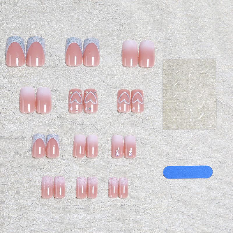 Artificial nails with sparkling heart designs and glitter details Bowlift
