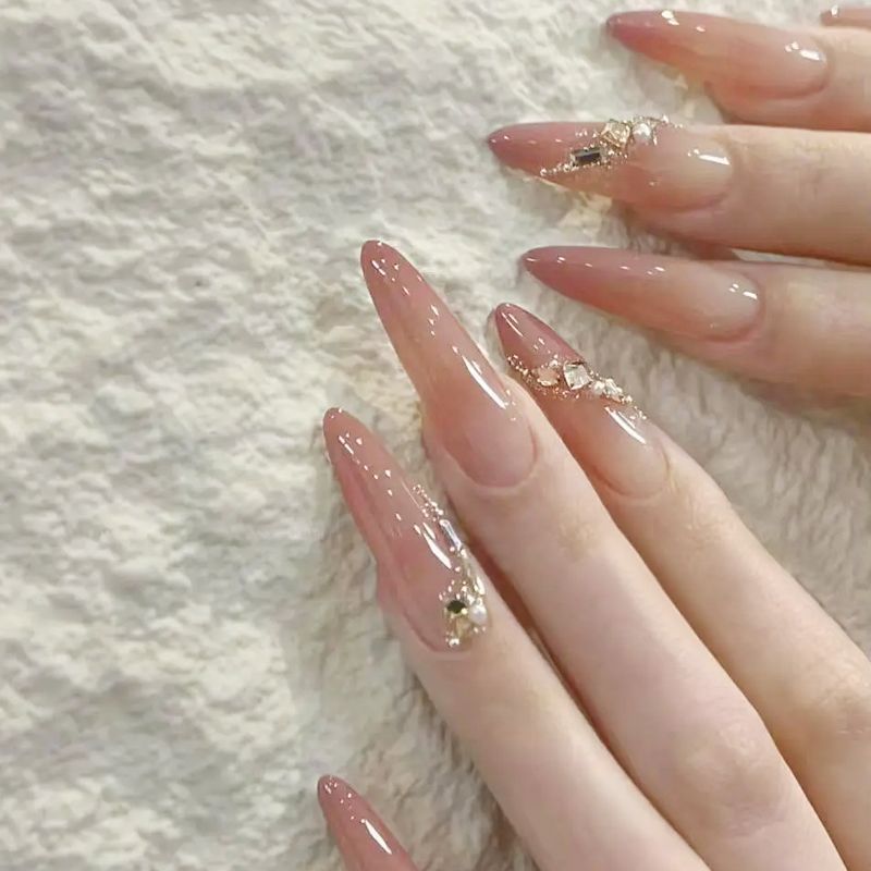 Acrylic nail set with elegant tips and glamorous rhinestone accents Bowlift