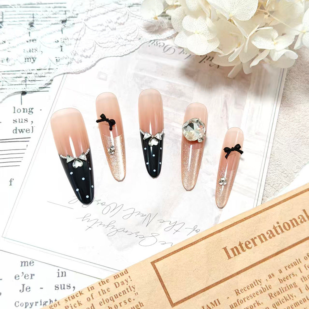 Elegantly designed artificial nails in luxurious design with decorative rhinestone applications Bowlift