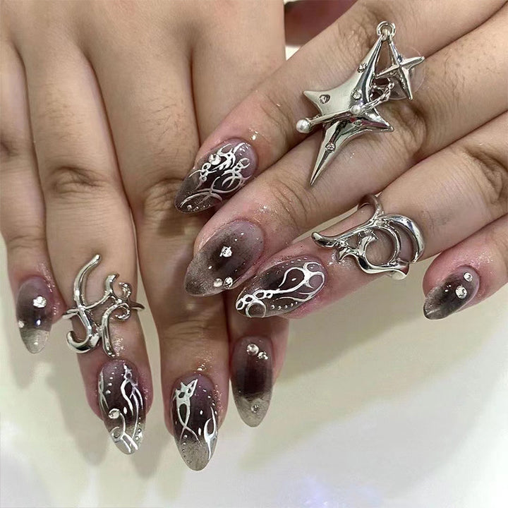 Artistic gel nails with delicate ornaments and glitter Bowlift