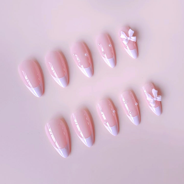 Artificial nail set with shimmering 3D bows and elegant pearl accents Bowlift