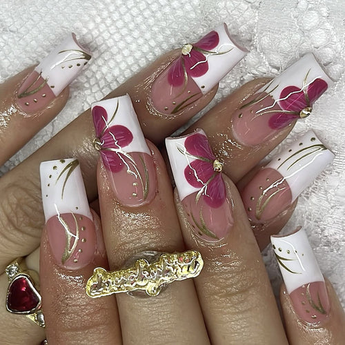 Artificial nail set with floral detail and glitter accents Bowlift