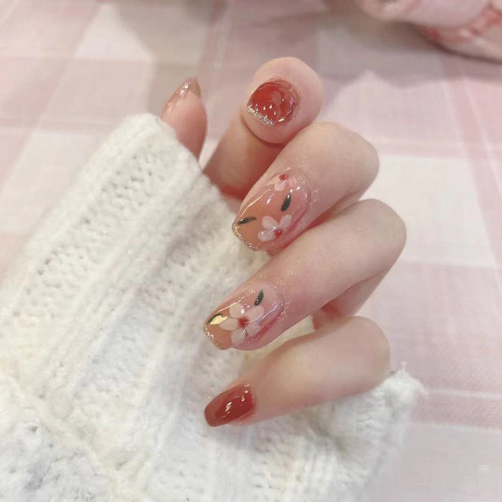 Artful nail art with floral motifs and glitter accents Bowlift