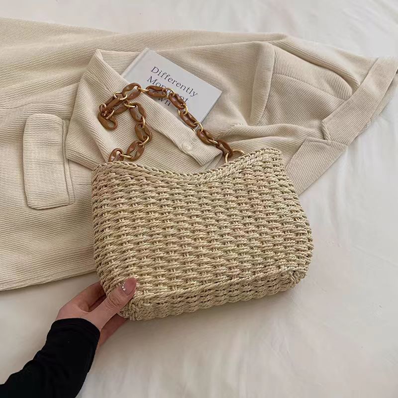 Handcrafted straw bag with golden chain details Bowlift