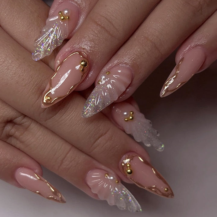Artful stiletto nails with elegant gold embellishment design Bowlift