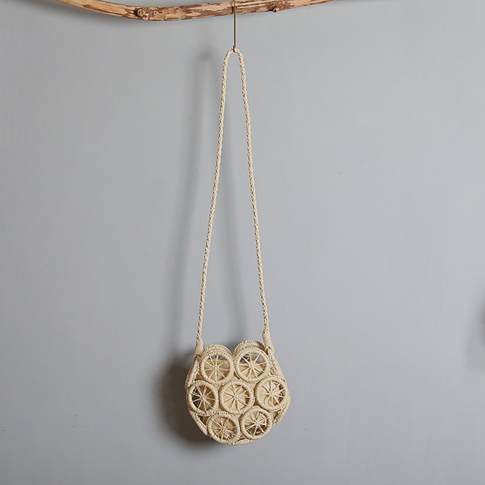 Shoulder bag made of handwoven raffia with intricate embellishments Bowlift