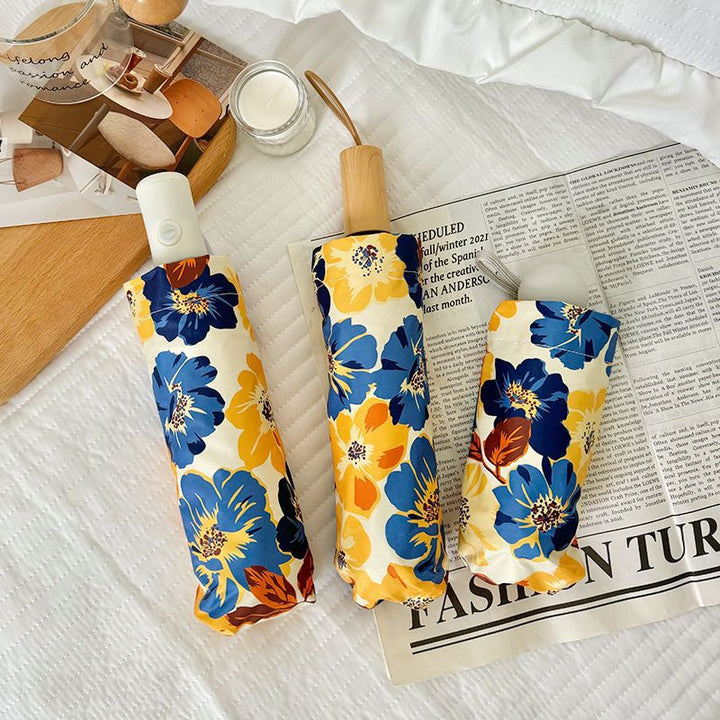 Women Folding Umbrella with Detailed Floral Design Bowlift