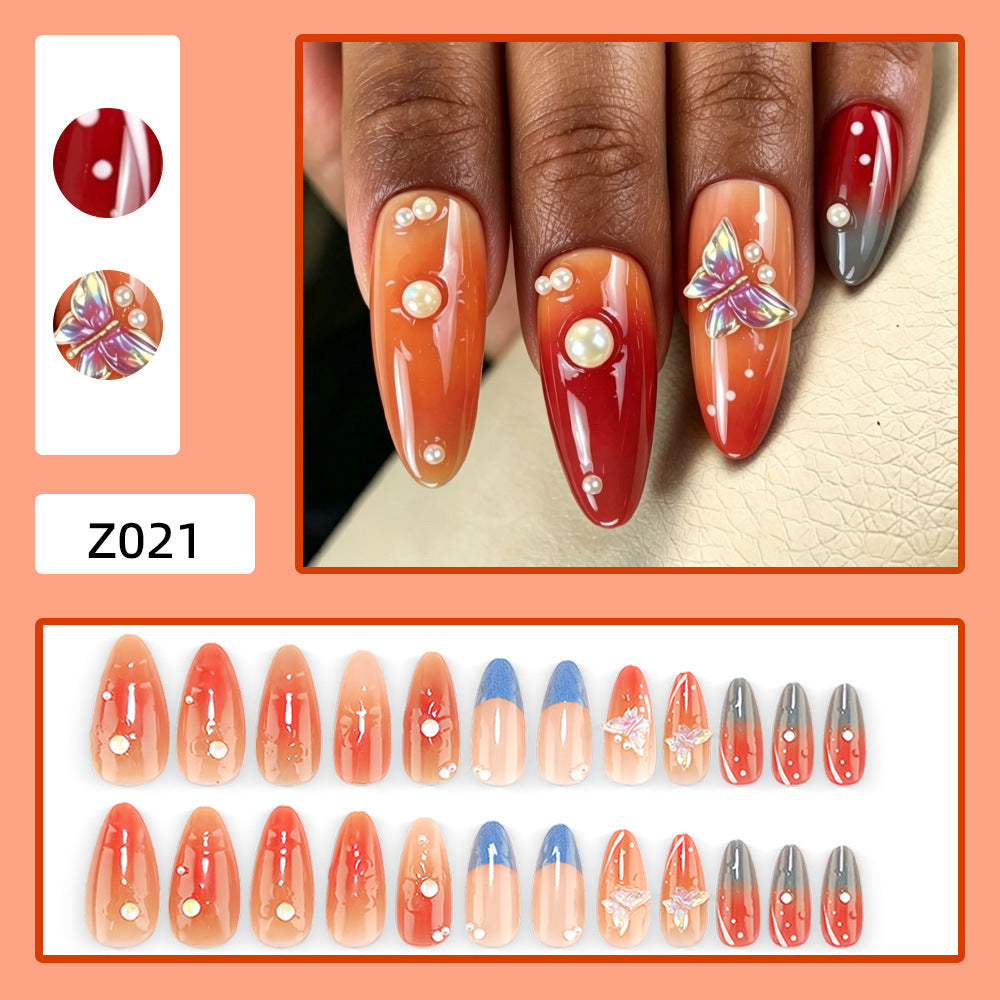 Artful nail art with pearls and butterfly details Bowlift