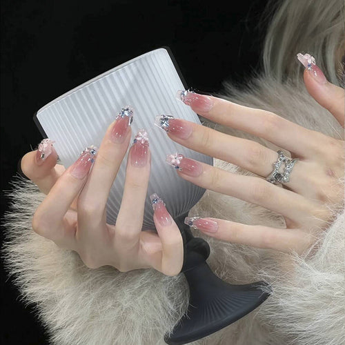 Artificial nail set with glamorous 3D decorations and shimmering accents Bowlift