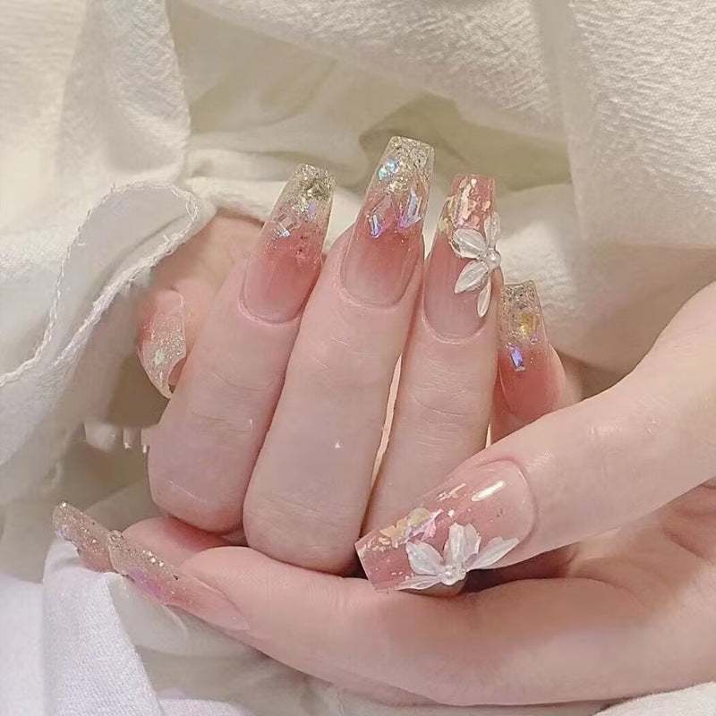 Glamorous artificial nails with delicate flower and glitter effects Bowlift