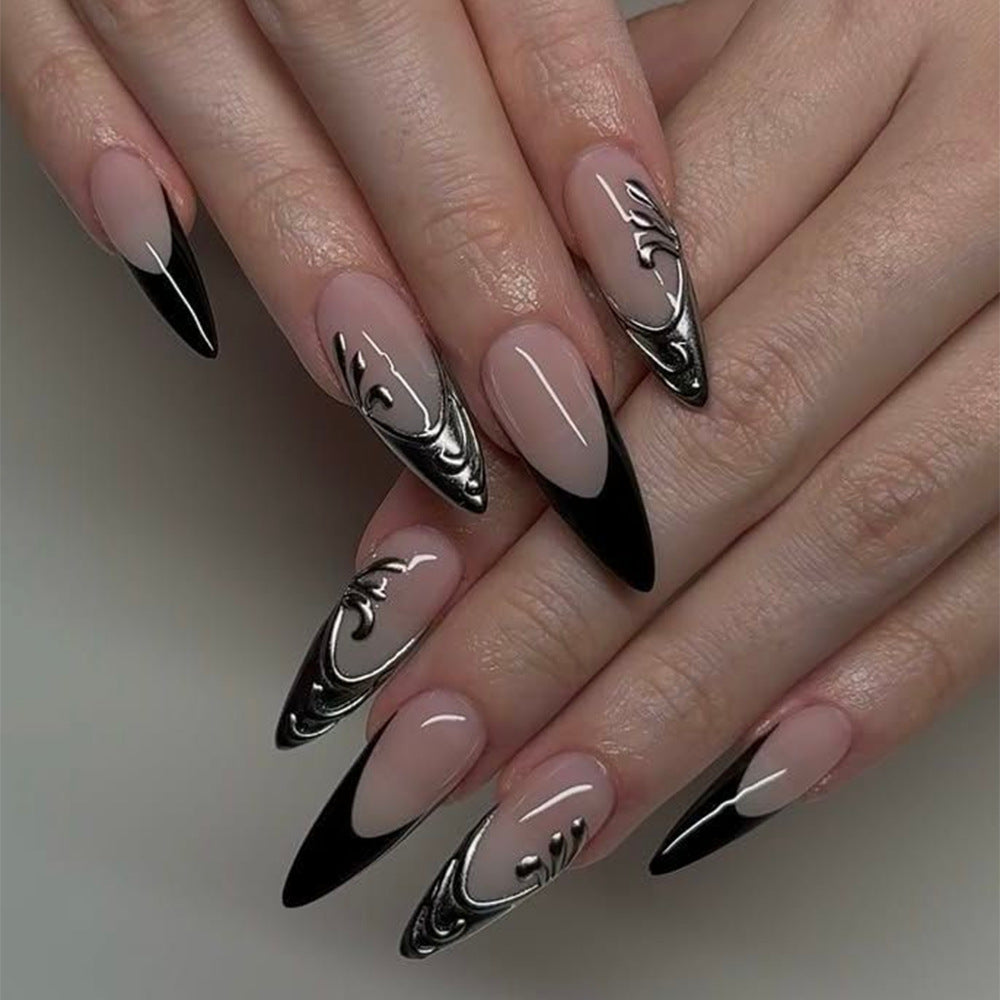 Artificial nails in elegant stiletto style with elaborate metal decoration Bowlift