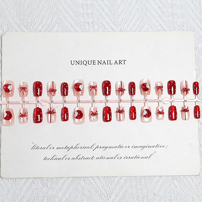 Artificial nail set with festive gift design and elegant glitter accents Bowlift