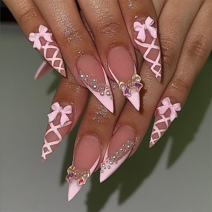 Artful stiletto nails with glitter and bow decoration Bowlift