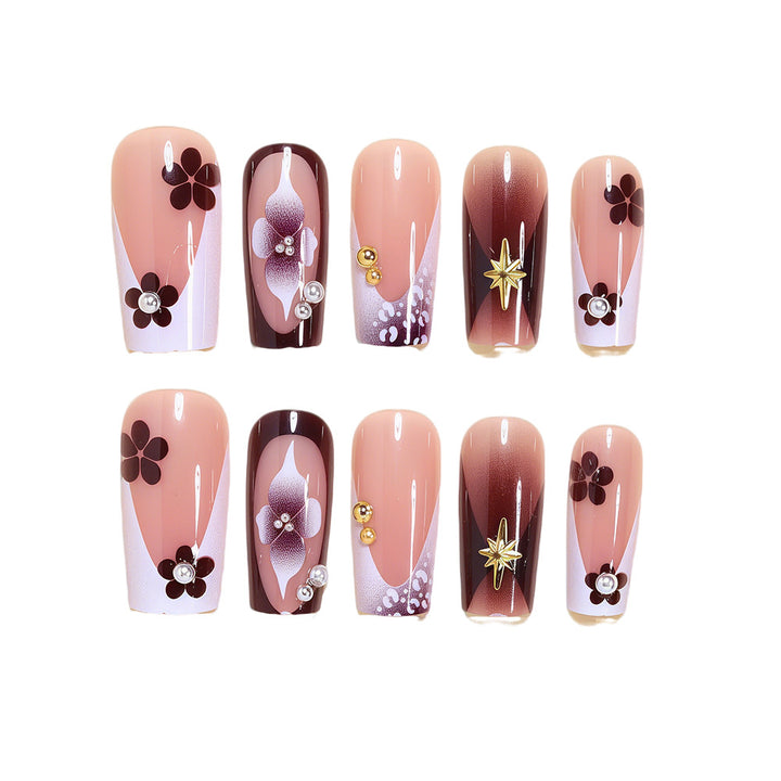 Artistic Acrylic Nail Design Set with Floral and Gold Accents Bowlift