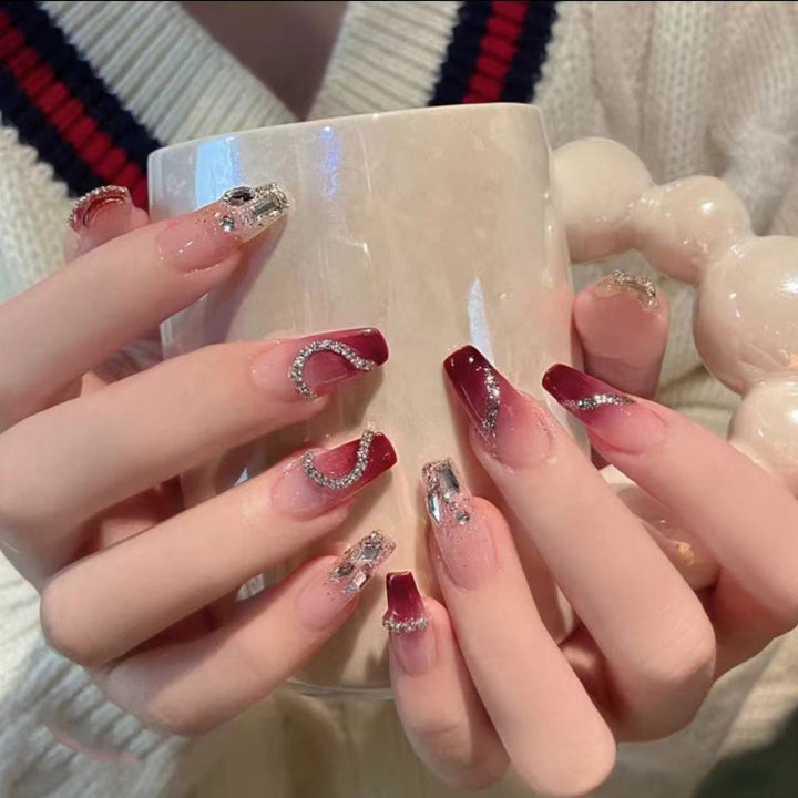 Glamorous artificial nails with heart-shaped accents Bowlift