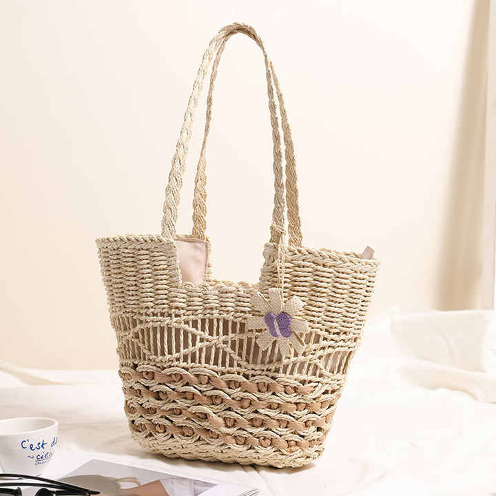 Braided basket bag with decorative flower appliqué Bowlift