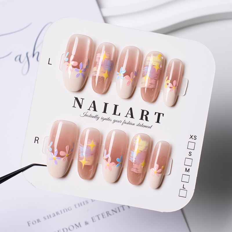 Artificial nails with delicate floral accents and glitter effects Bowlift