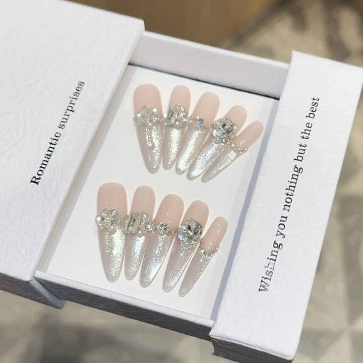 Glamorous artificial nails with sparkling rhinestone embellishments Bowlift