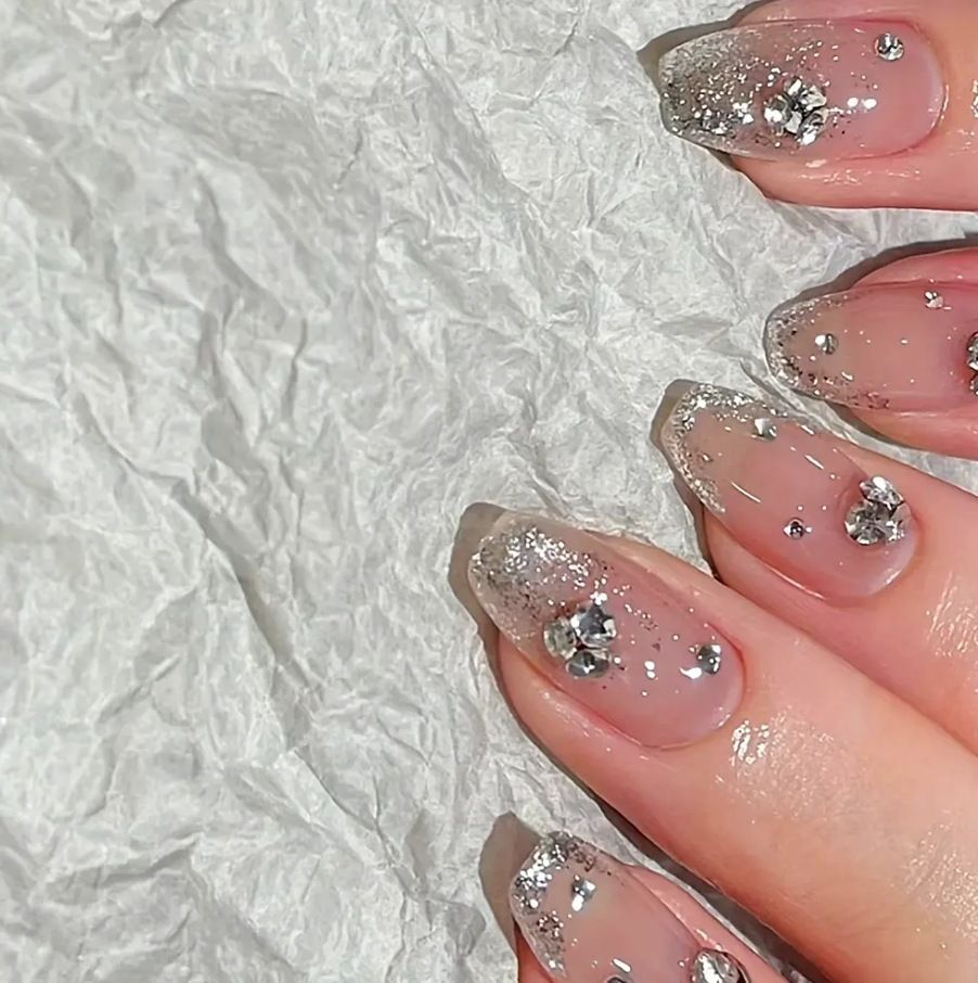 Acrylic nail set with extravagant glitter and crystal embellishments Bowlift