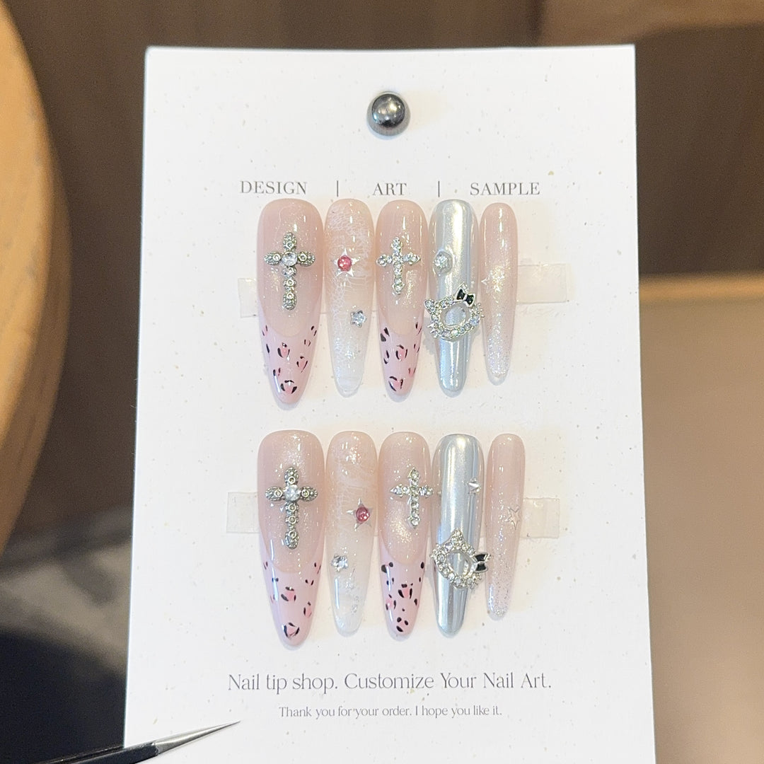 Artificial nails with sparkling rhinestones and cross motifs Bowlift
