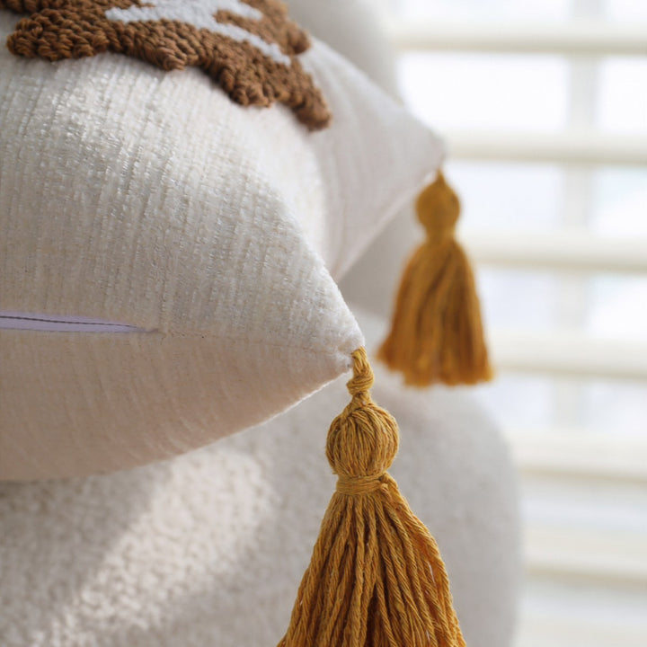Rectangular decorative cushion cover made of linen look with raised leaf appliqués and corner tassels Bowlift