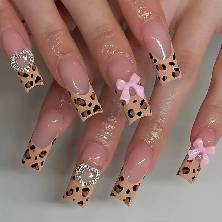 Creative nail set with leopard pattern and bow accents Bowlift