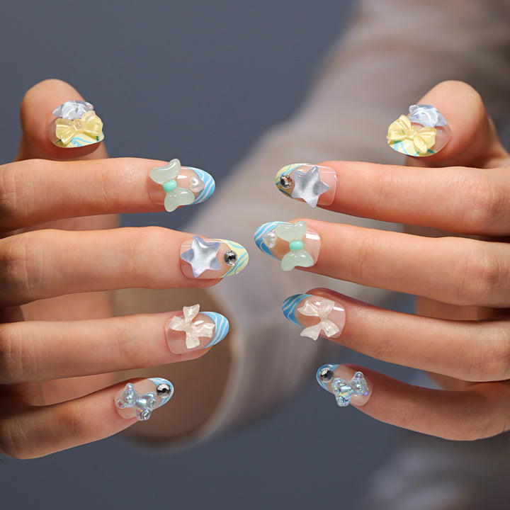 Artificial nail art with colorful pastel designs and 3D embellishments Bowlift