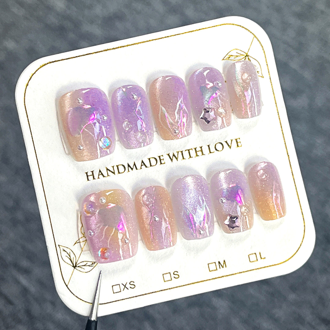 Artificial nail art with sparkling accents and transparent color gradient Bowlift