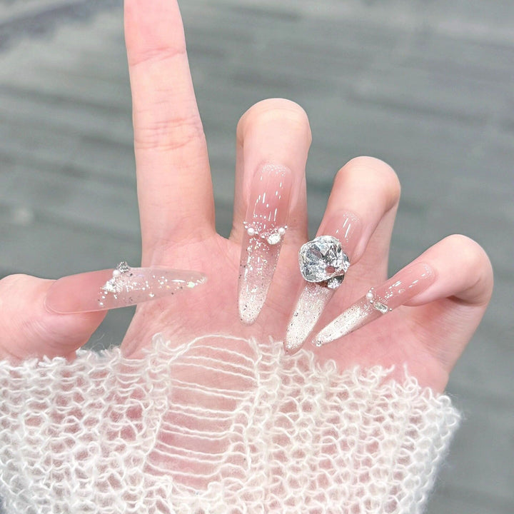 Artificial nails with glitter and crystal embellishments Bowlift