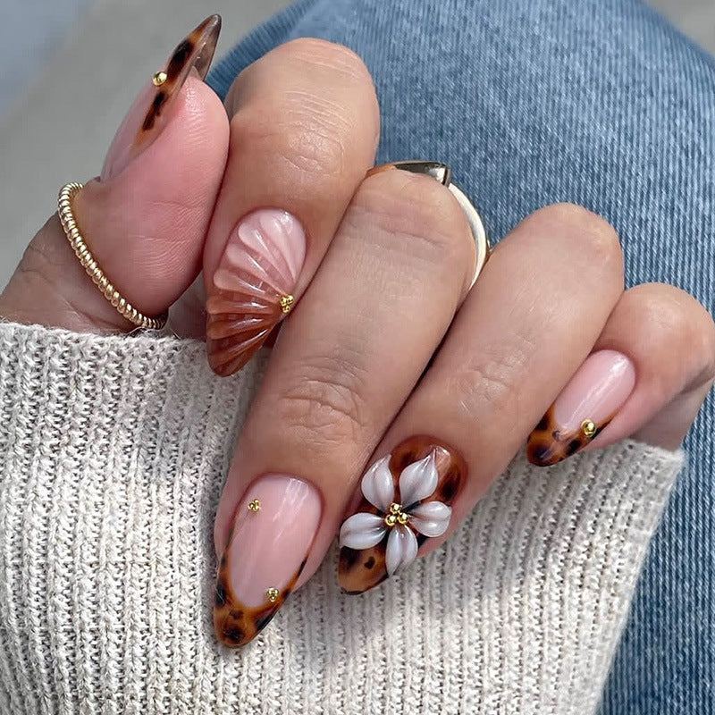 Nail art set with detailed ombre design and creative flower accents Bowlift
