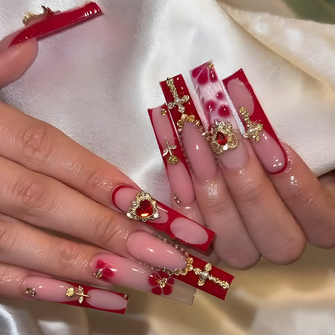 Glamorous Stiletto Press-On Nails with Artistic Gold and Red Accents Bowlift