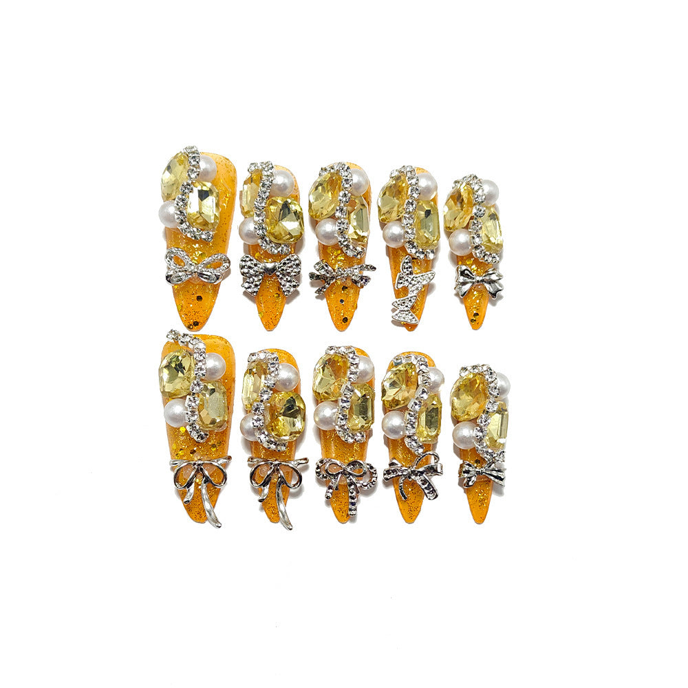 Glamorous artificial nails with rhinestones and pearl embellishments Bowlift