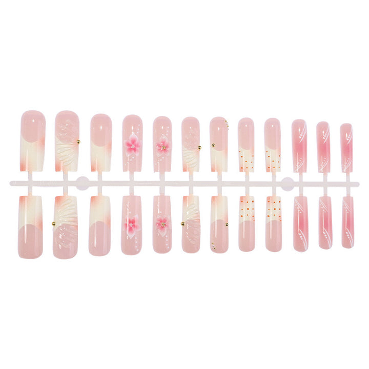 Artificial nail set with delicate flower and glitter accents Bowlift