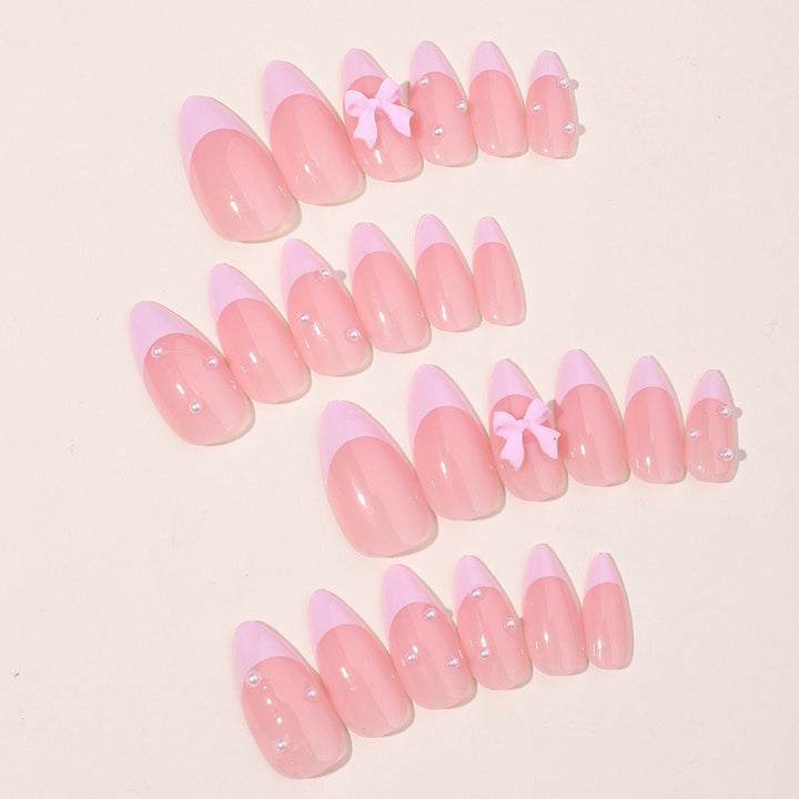 Artificial nail set with delicate bow and glitter accents Bowlift