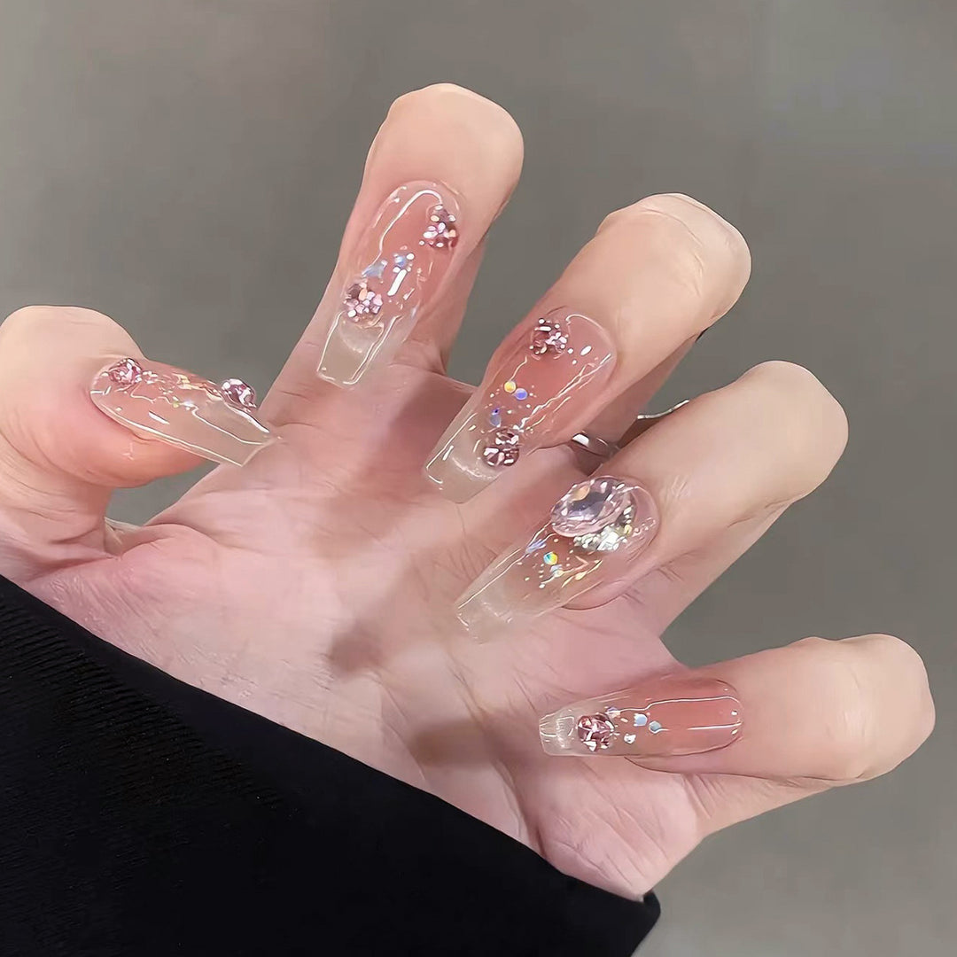 Artificial nail extensions with artistic glitter accents Bowlift