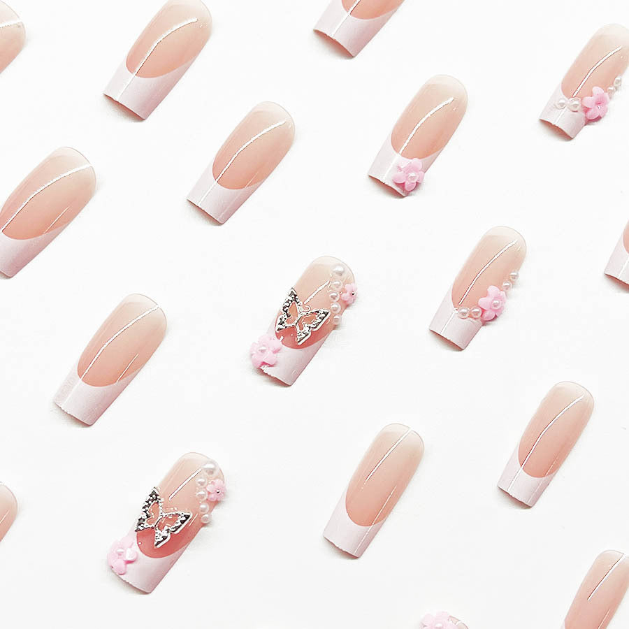 Artificial nail set with playful 3D flowers and glitter accents Bowlift