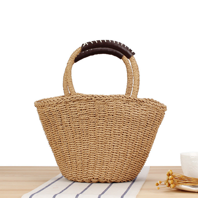 Basket bag made of woven natural material with leather handles Bowlift