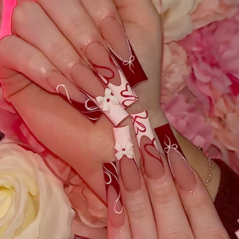 artistic nail set with heart and bow motifs Bowlift