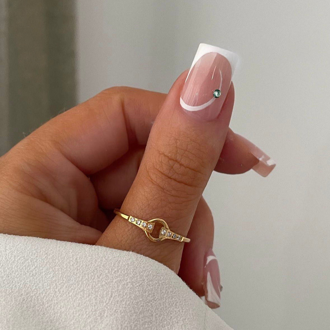 Artificial nail set with elegant French tips and glamorous rhinestone decorations Bowlift