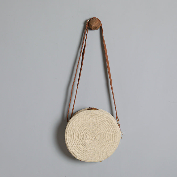 Round shoulder bag made of natural material with stylish accents Bowlift