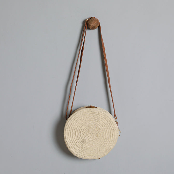 Round shoulder bag made of natural material with stylish accents Bowlift
