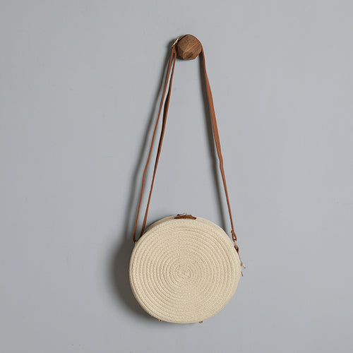Round shoulder bag made of natural material with stylish accents Bowlift